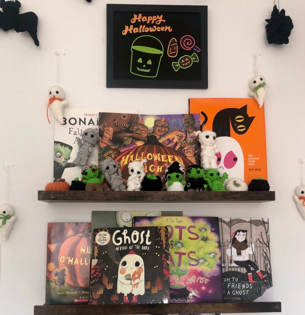 Children decorated Halloween bookshelves with sign